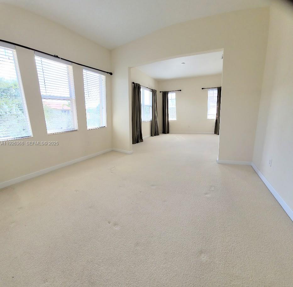 6033 Northwest 118th Drive, Unit 6033 Coral Springs, FL 33076 - Photo 24 of 43 an empty room with windows and bathroom