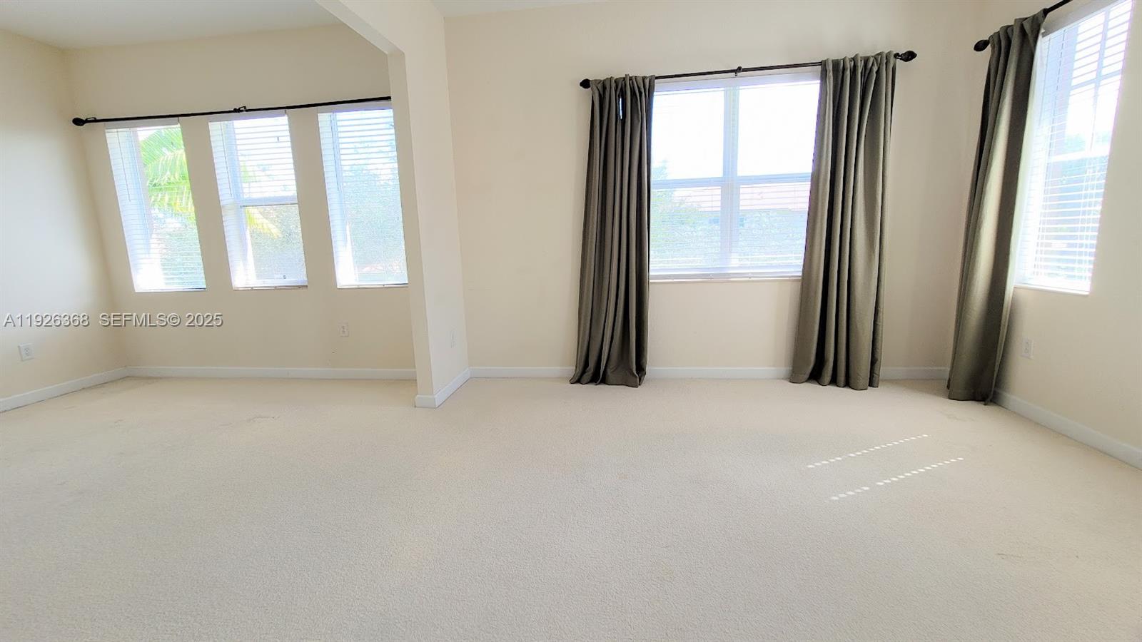6033 Northwest 118th Drive, Unit 6033 Coral Springs, FL 33076 - Photo 25 of 43 an empty room with windows