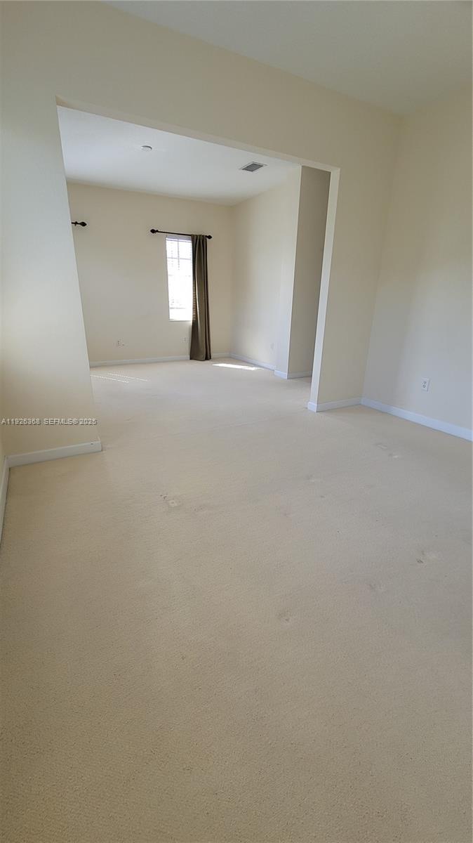 6033 Northwest 118th Drive, Unit 6033 Coral Springs, FL 33076 - Photo 27 of 43 a view of wooden floor and windows in a room
