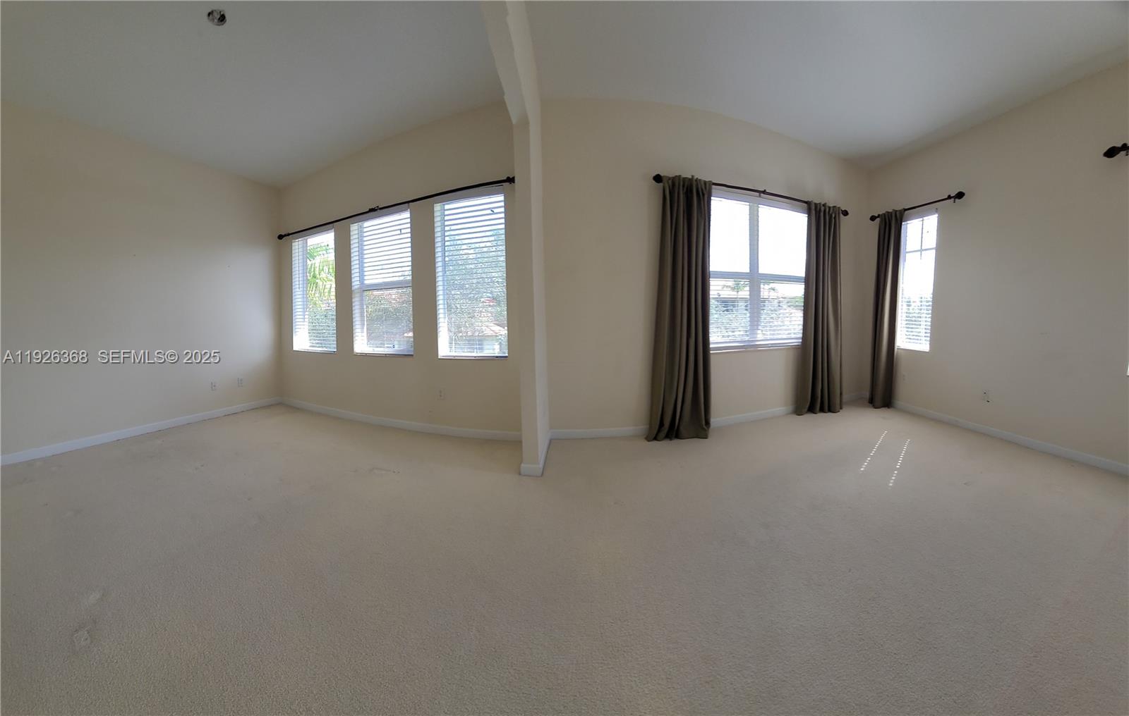 6033 Northwest 118th Drive, Unit 6033 Coral Springs, FL 33076 - Photo 28 of 43 an empty room with windows