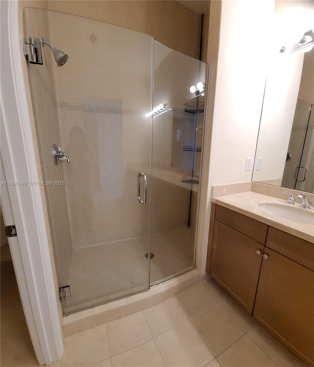 6033 Northwest 118th Drive, Unit 6033 Coral Springs, FL 33076 - Photo 30 of 43 a bathroom with a shower and a sink