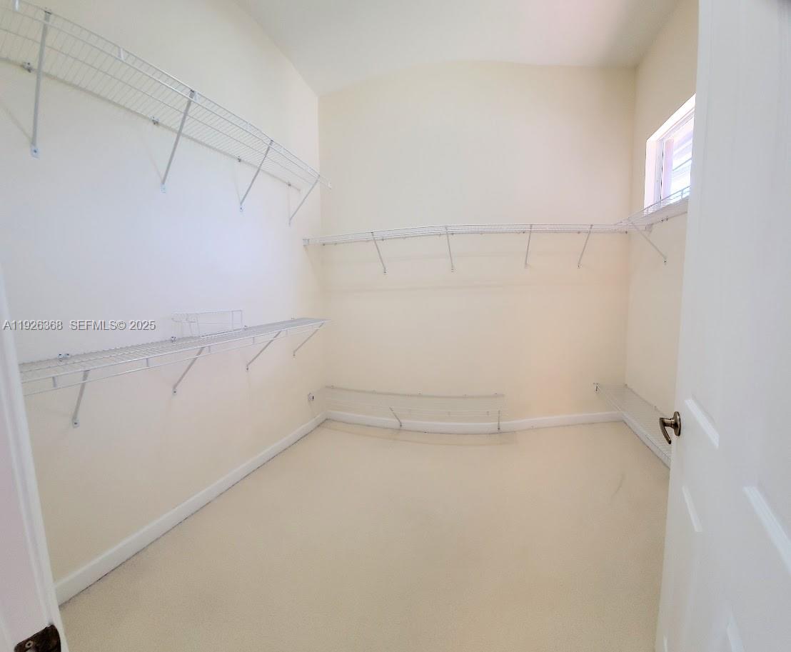 6033 Northwest 118th Drive, Unit 6033 Coral Springs, FL 33076 - Photo 32 of 43 a view of a room with racks on the wall
