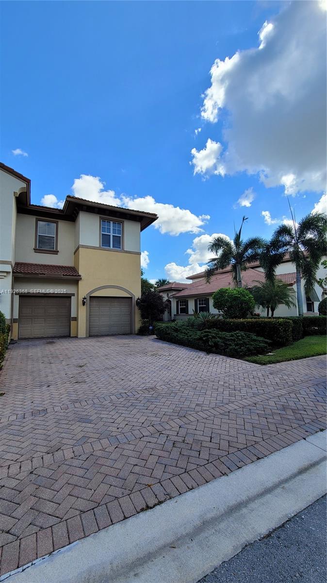 6033 Northwest 118th Drive, Unit 6033 Coral Springs, FL 33076 - Photo 35 of 43 a view of a house with a yard