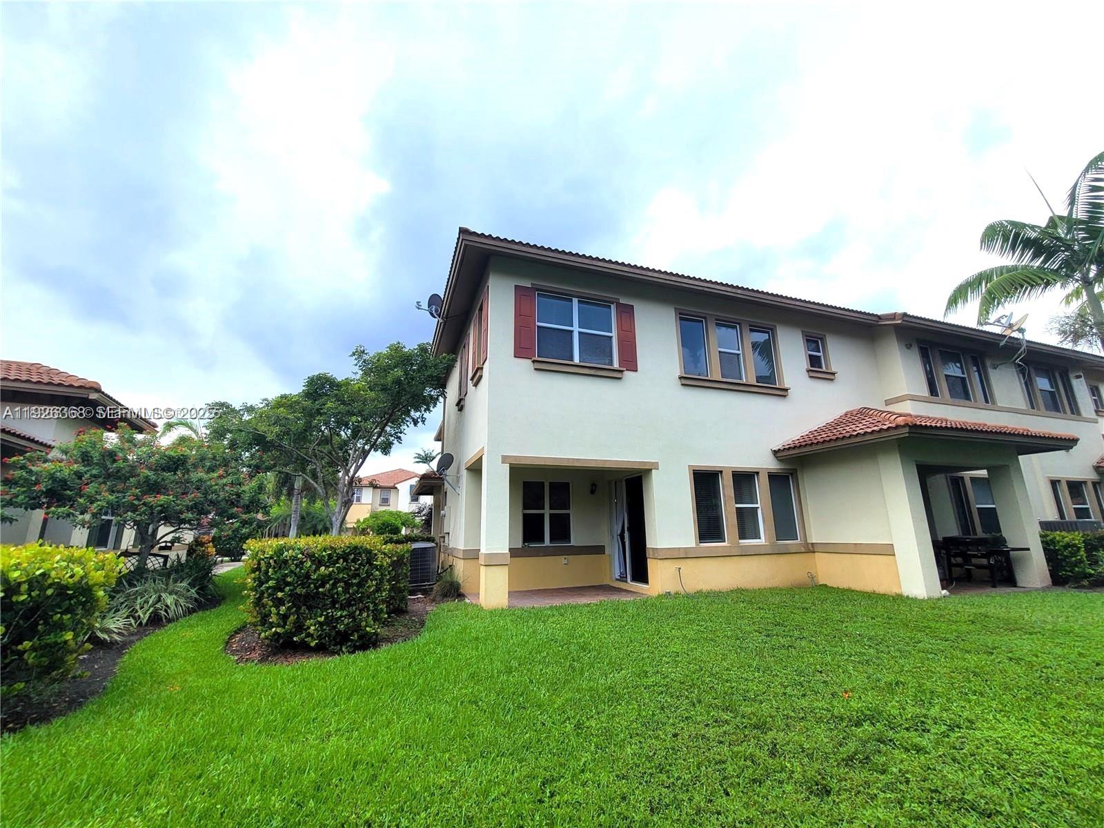 6033 Northwest 118th Drive, Unit 6033 Coral Springs, FL 33076 - Photo 41 of 43 a view of an house with backyard space and garden