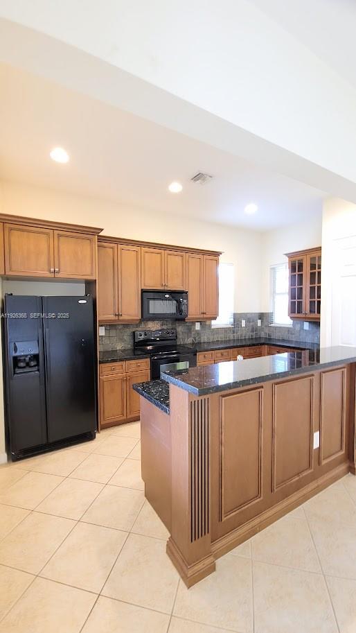 6033 Northwest 118th Drive, Unit 6033 Coral Springs, FL 33076 - Photo 7 of 43 a kitchen with stainless steel appliances kitchen island granite countertop a refrigerator and cabinets