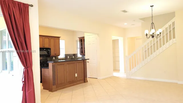 a view of a kitchen with a sink and cabinets