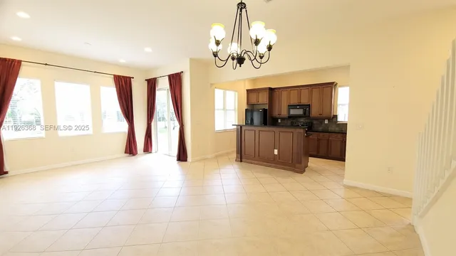 a kitchen with stainless steel appliances granite countertop a sink and a microwave