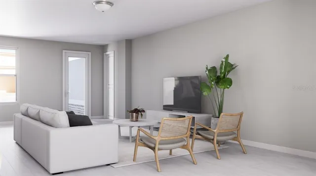 a living room with furniture and a potted plant