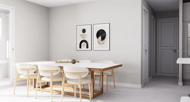 a view of a dining room that has a table and chairs in it