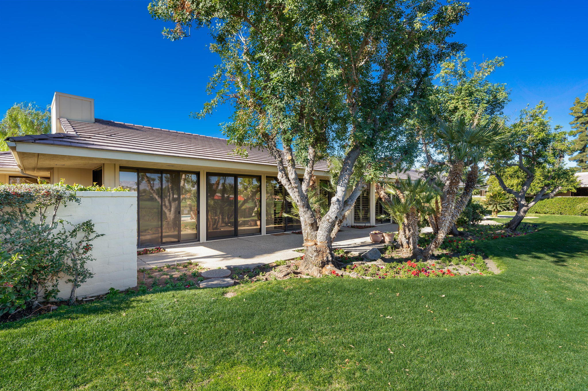 1 Hamlet Court Rancho Mirage, CA 92270 - Photo 12 of 41 a view of a house with backyard and a tree