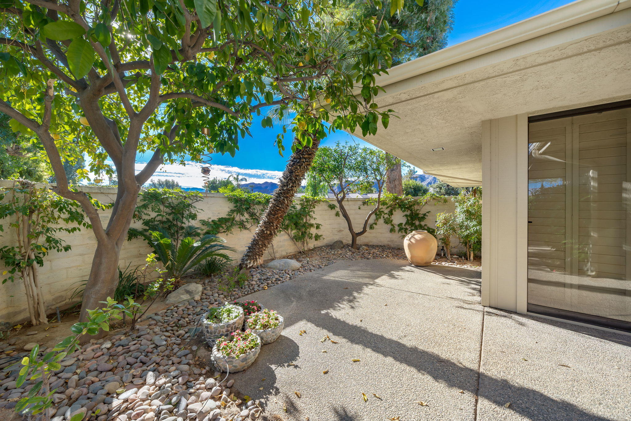 1 Hamlet Court Rancho Mirage, CA 92270 - Photo 16 of 41 a backyard of a house with outdoor seating