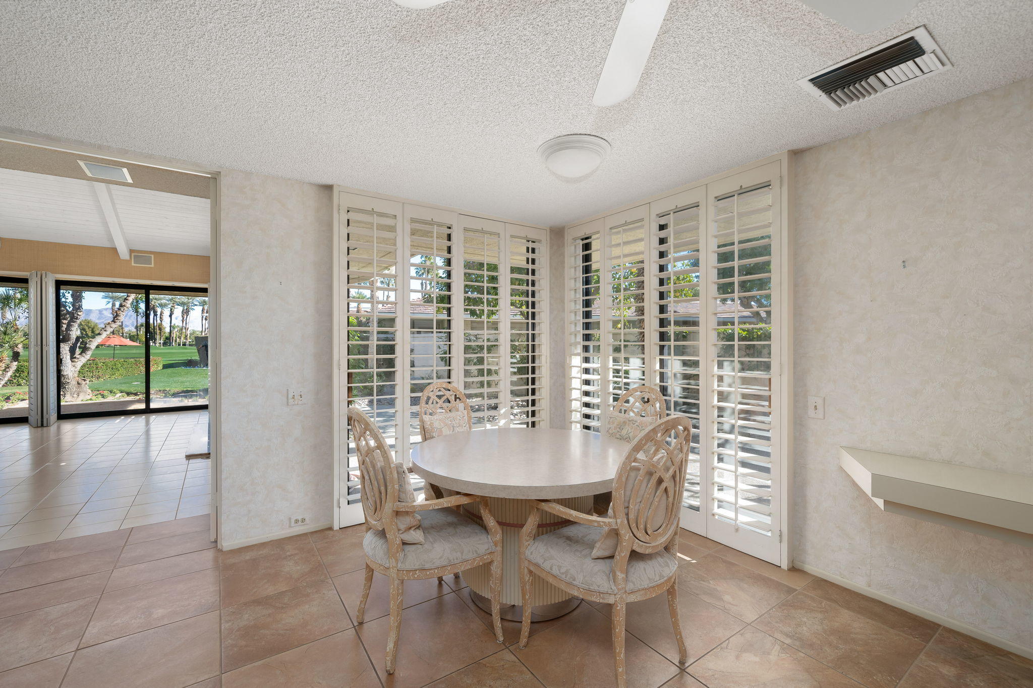 1 Hamlet Court Rancho Mirage, CA 92270 - Photo 19 of 41 a view of a dining room with furniture window and outside view