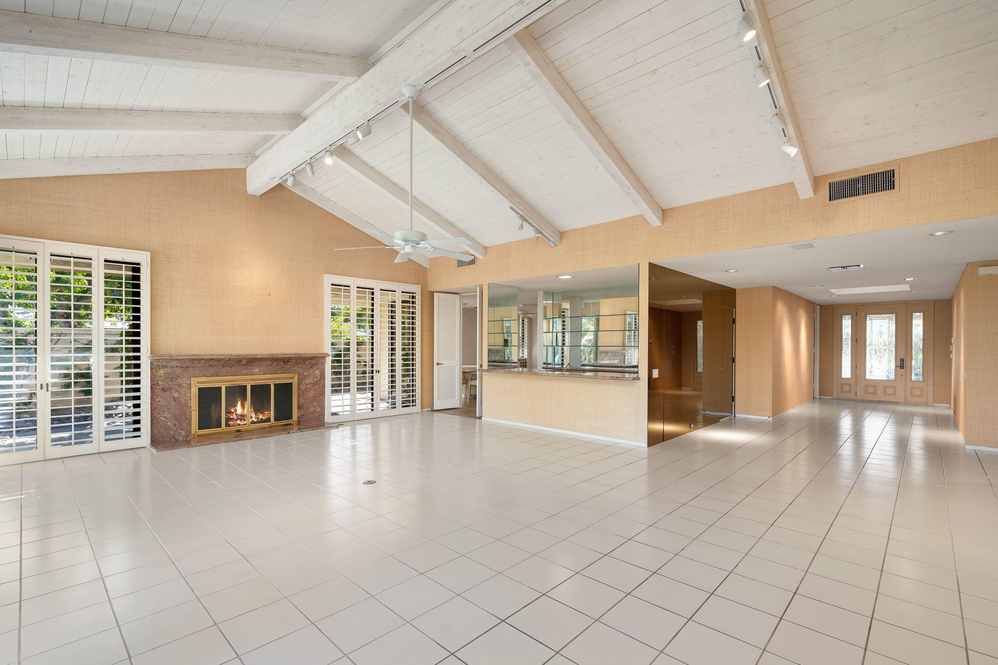 1 Hamlet Court Rancho Mirage, CA 92270 - Photo 10 of 41 a view of an empty room with a fireplace and large windows