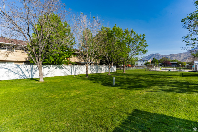 728 400 East Orem, UT 84097 - Photo 26 of 30 Expansive green lawn area featuring mature trees and a white privacy fence
