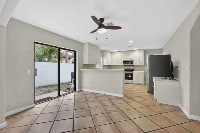 a kitchen with stainless steel appliances granite countertop a refrigerator and a sink