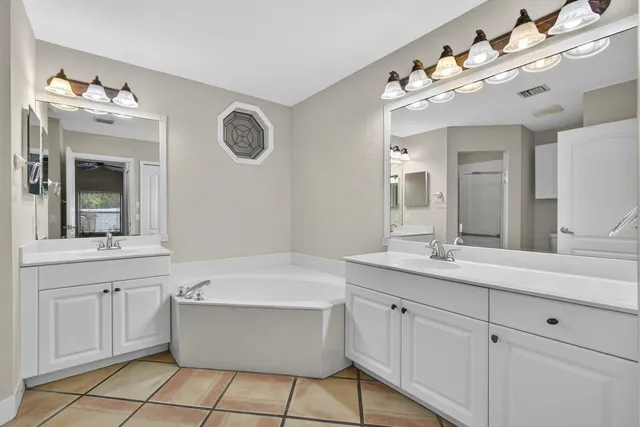 an empty room with windows and ceiling fan