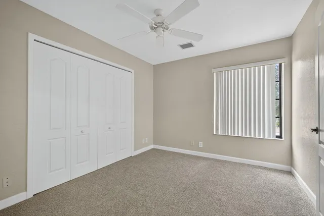 a view of a swimming pool with a yard and sitting area