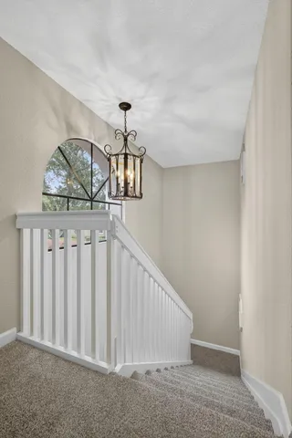 an aerial view of a house with a garden and lake view
