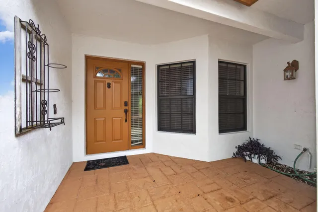 a view of a hallway and an dining rom with furniture