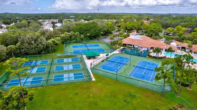 a room with pool table and windows