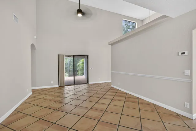 a view of kitchen with furniture electronic appliances and window