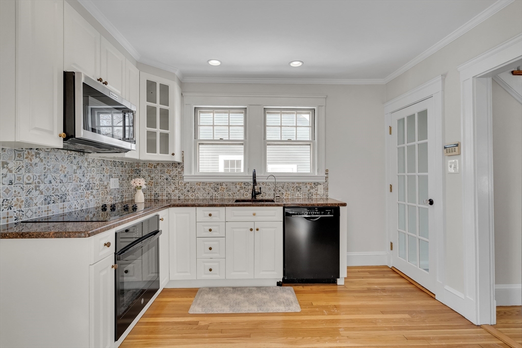 10 Dexter Road Lexington, MA 02420 - Photo 15 of 35 a kitchen with stainless steel appliances granite countertop a stove a sink and a refrigerator