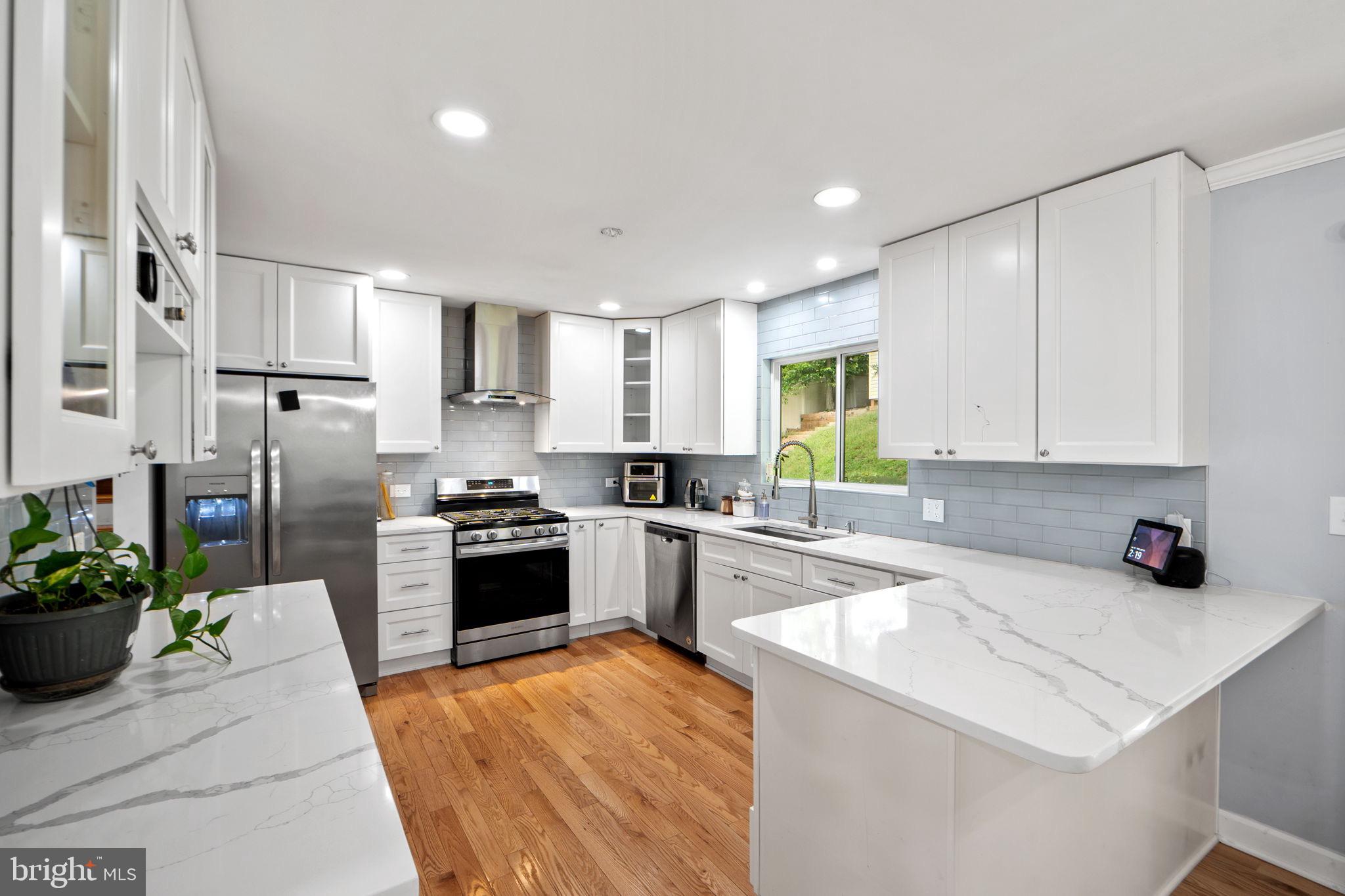 7222 Willow Oak Place Springfield, VA 22153 - Photo 13 of 34 a kitchen with a sink stainless steel appliances and cabinets