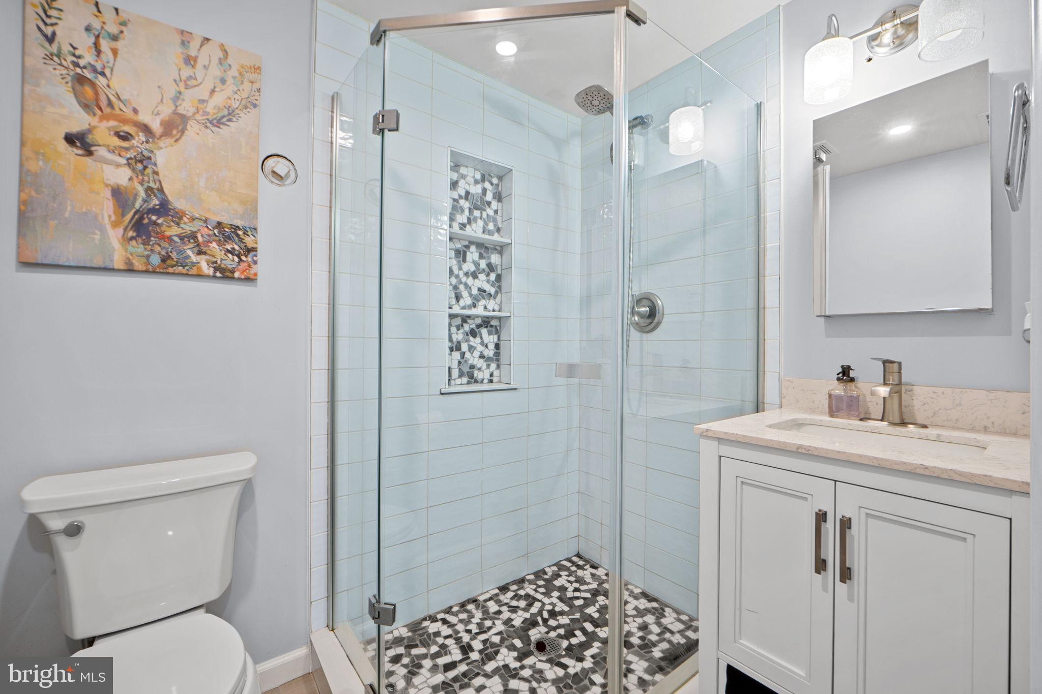 7222 Willow Oak Place Springfield, VA 22153 - Photo 16 of 34 a bathroom with a sink a toilet and shower