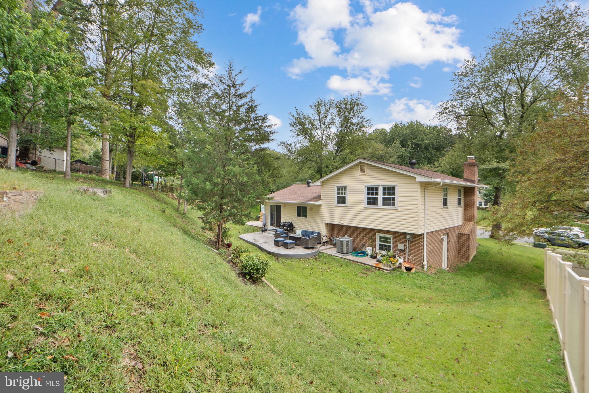 7222 Willow Oak Place Springfield, VA 22153 - Photo 30 of 34 a view of a house with a big yard and large trees