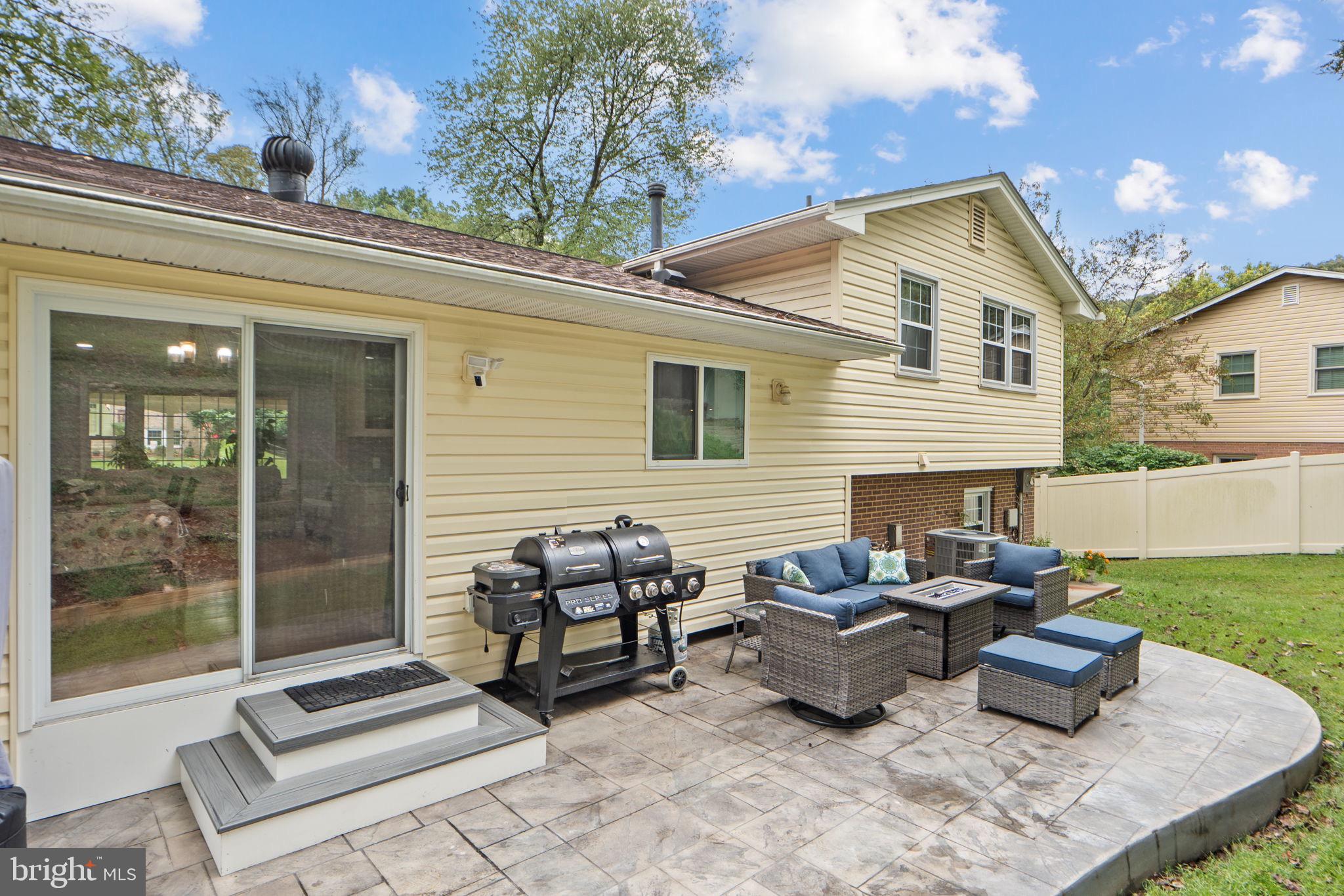7222 Willow Oak Place Springfield, VA 22153 - Photo 32 of 34 a view of a patio with couches and a table and chairs with garden view