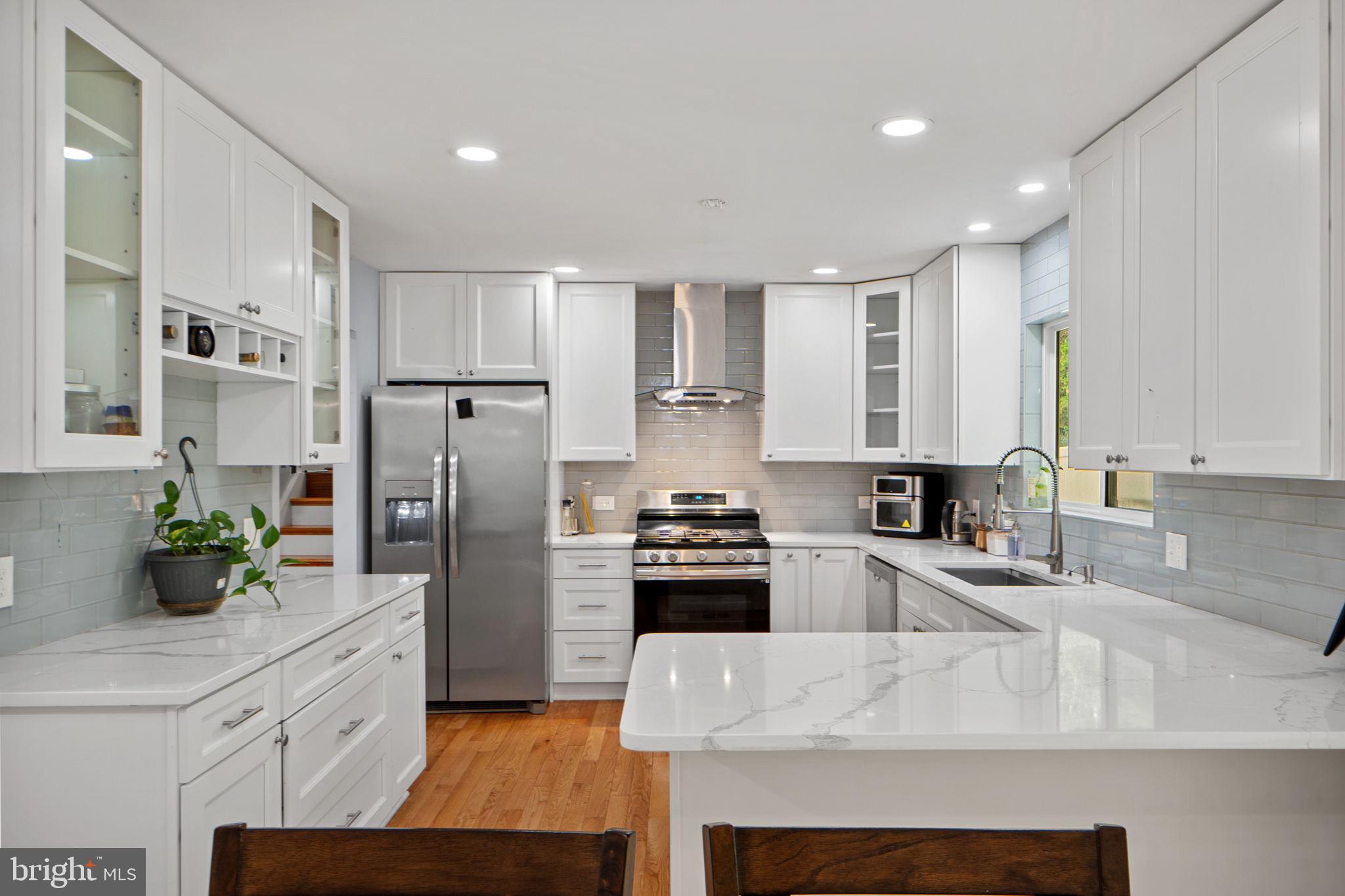 7222 Willow Oak Place Springfield, VA 22153 - Photo 7 of 34 a kitchen with refrigerator a stove and cabinets