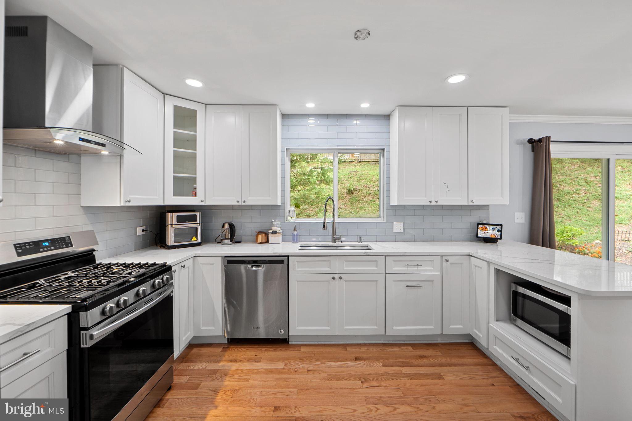 7222 Willow Oak Place Springfield, VA 22153 - Photo 8 of 34 a kitchen with stainless steel appliances a stove sink and cabinets