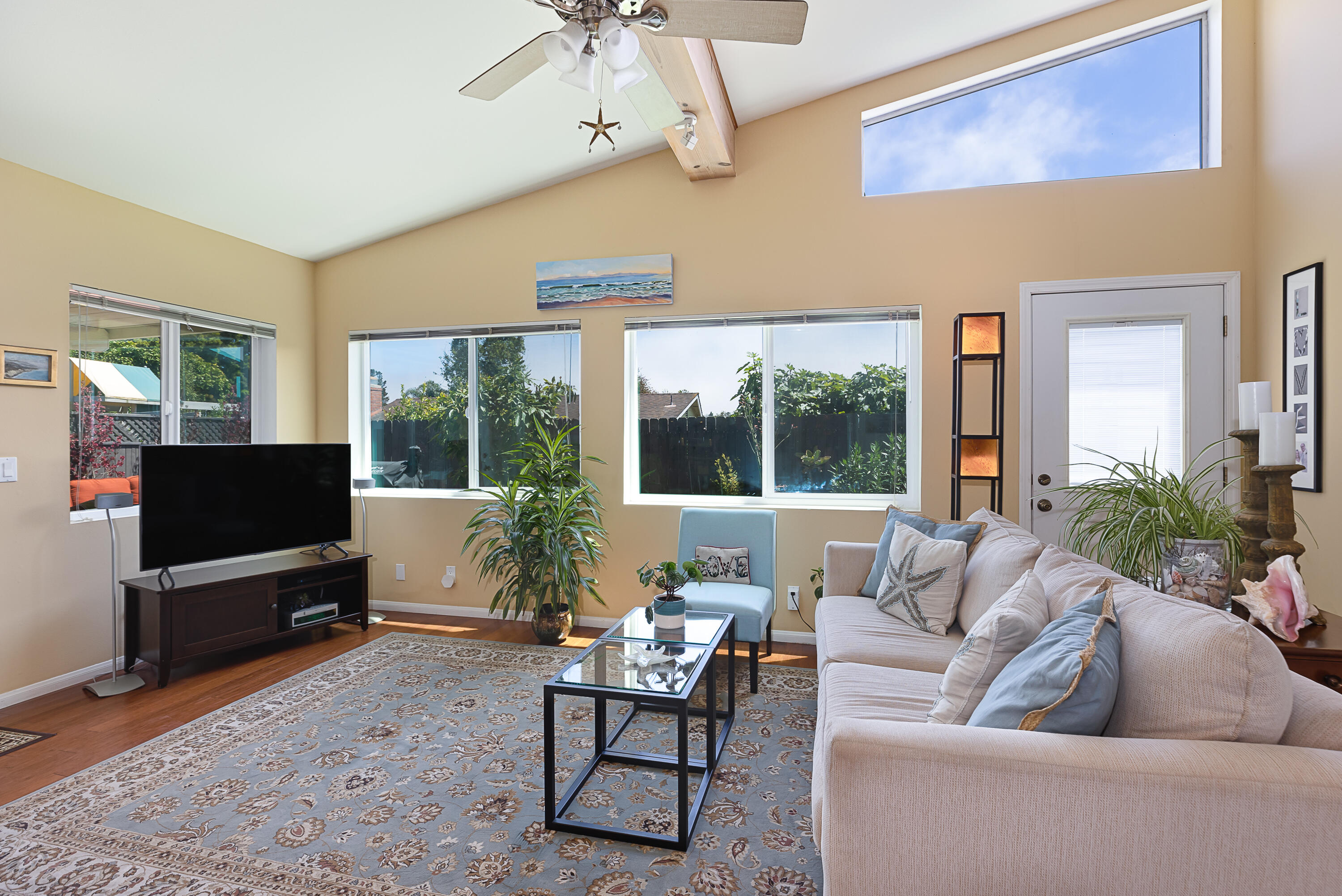 4655 Aragon Drive Carpinteria, CA 93013 - Photo 6 of 32 a living room with furniture a flat screen tv and a large window