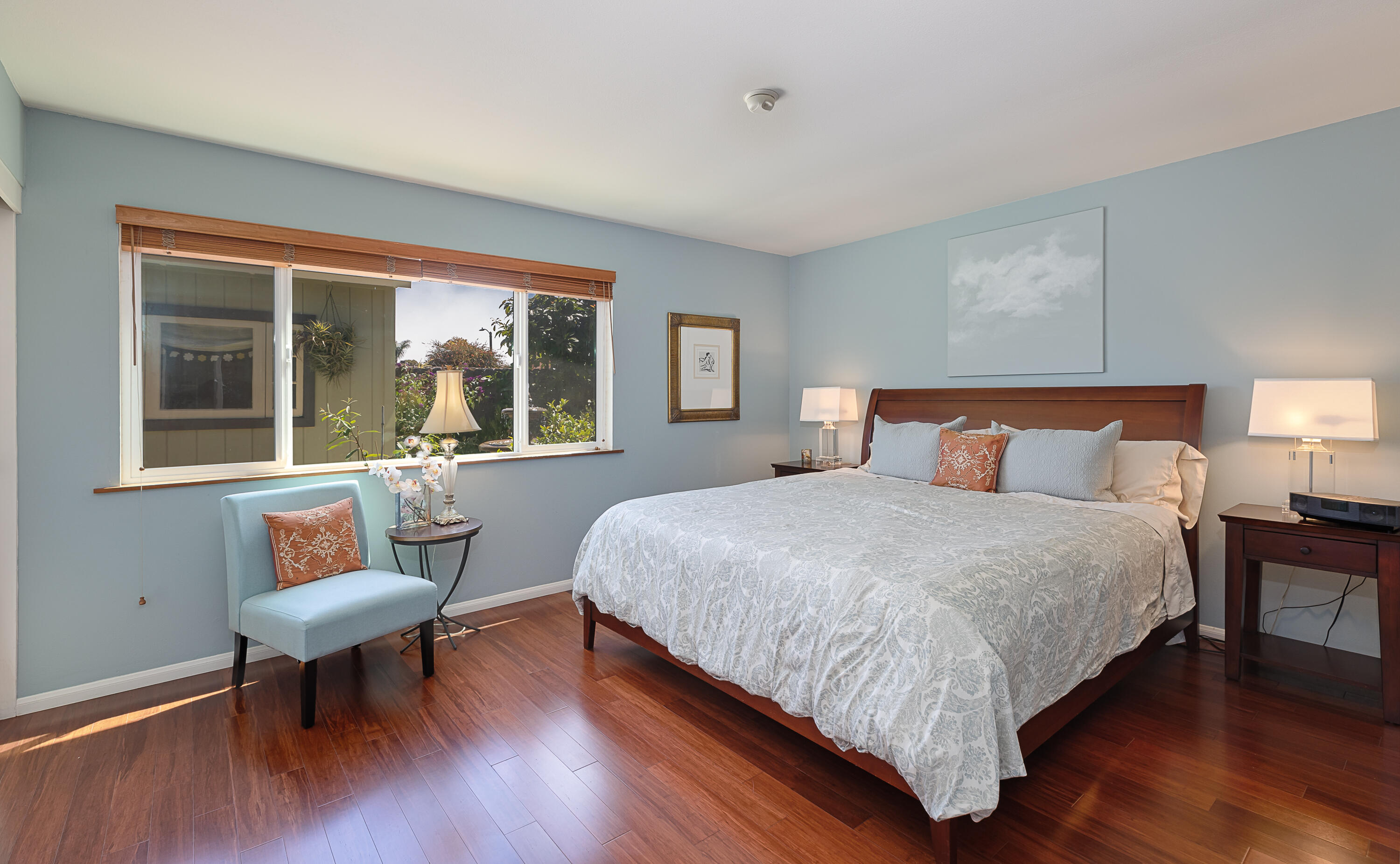 4655 Aragon Drive Carpinteria, CA 93013 - Photo 9 of 32 a bedroom with bed and a chair with wooden floor