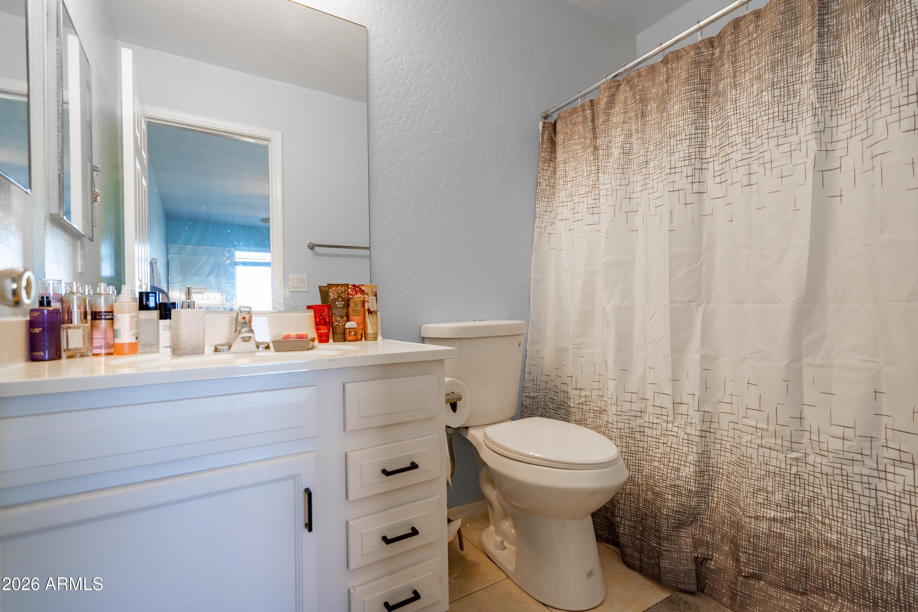 15855 South Moon Valley Road Arizona City, AZ 85123 - Photo 15 of 22 a bathroom with a toilet a sink and a mirror