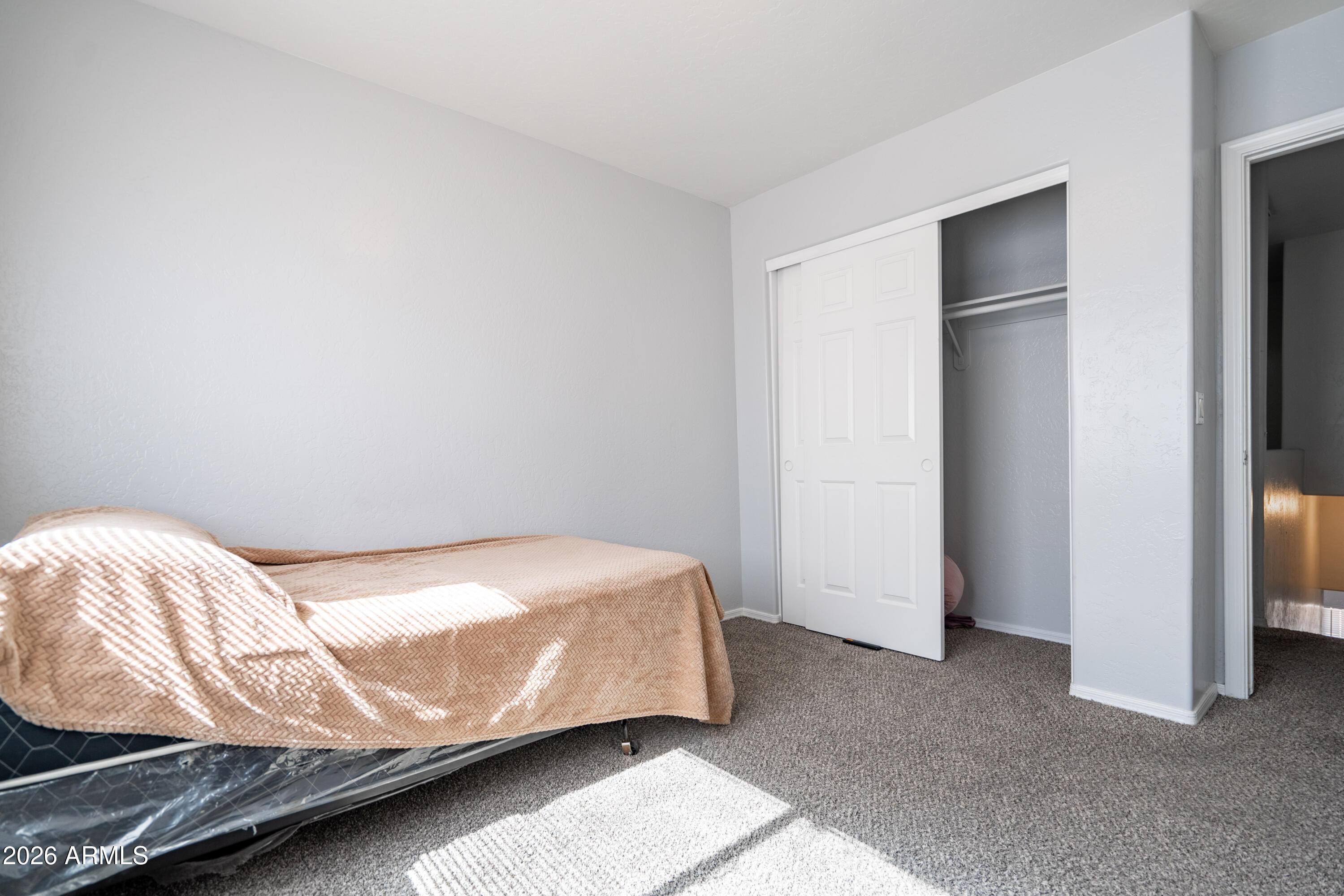 15855 South Moon Valley Road Arizona City, AZ 85123 - Photo 16 of 22 a bedroom with a bed and a cabinet