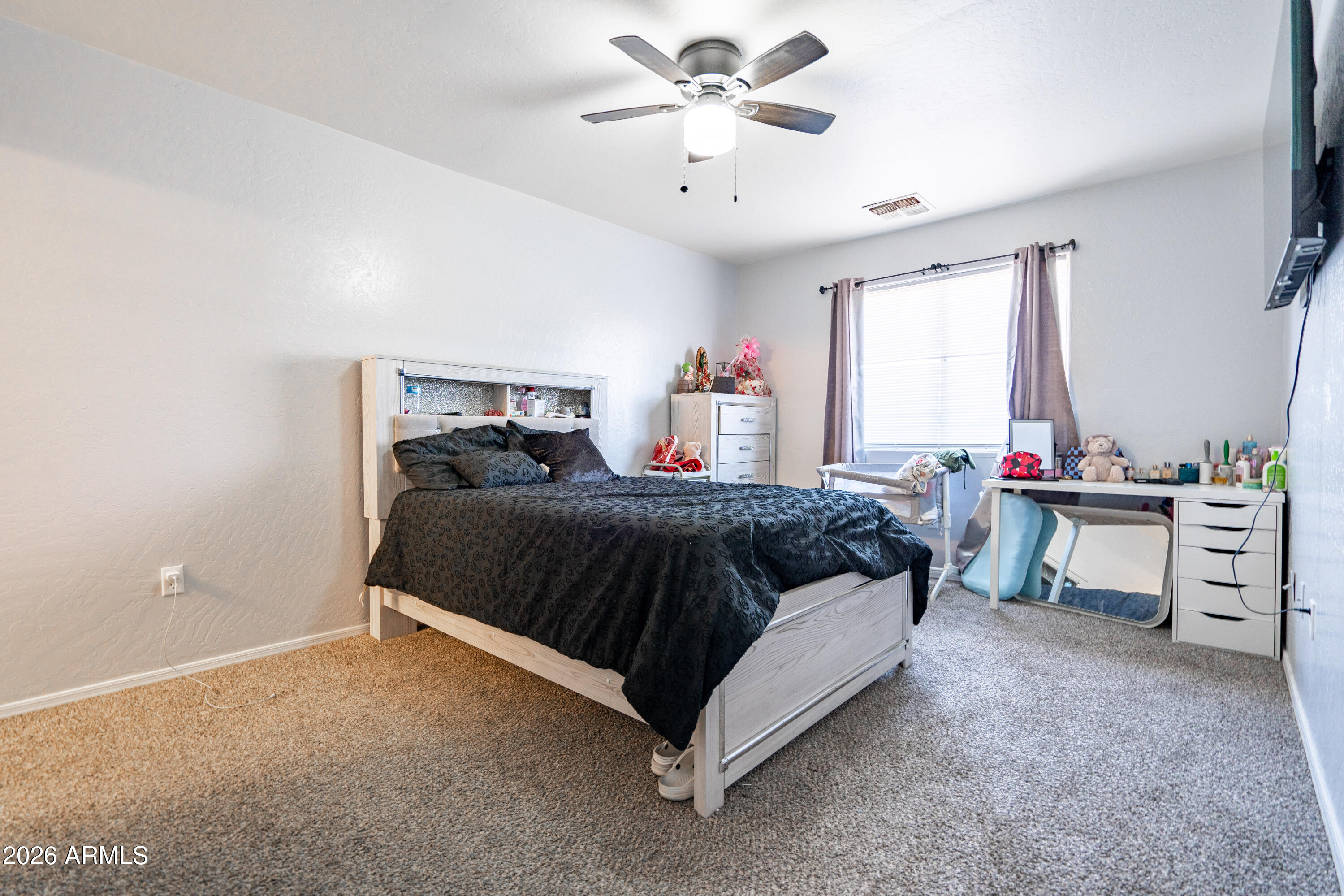 15855 South Moon Valley Road Arizona City, AZ 85123 - Photo 18 of 22 a bedroom with a bed and a chandelier