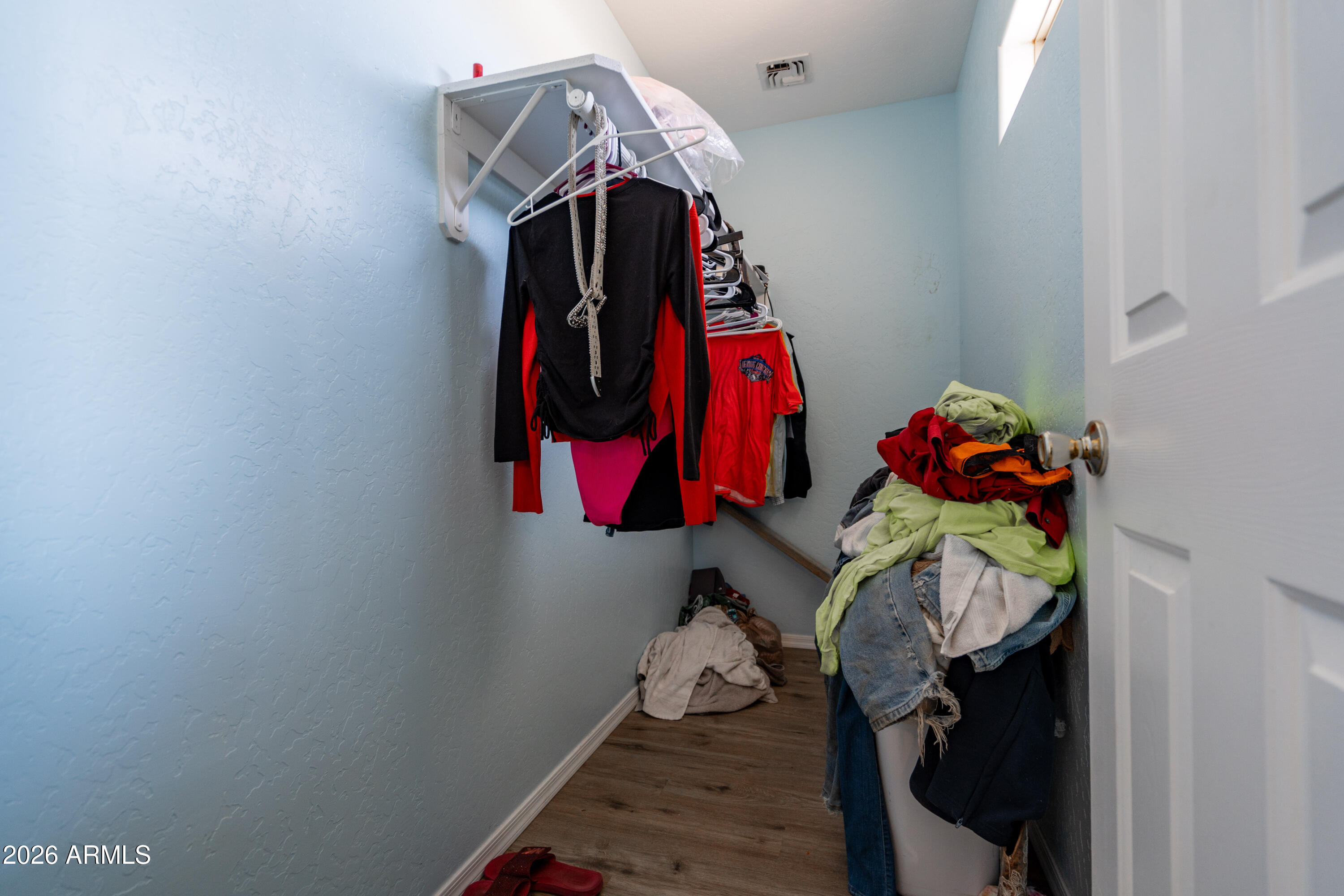 15855 South Moon Valley Road Arizona City, AZ 85123 - Photo 22 of 22 a view of walk in closet with clothes and shoes