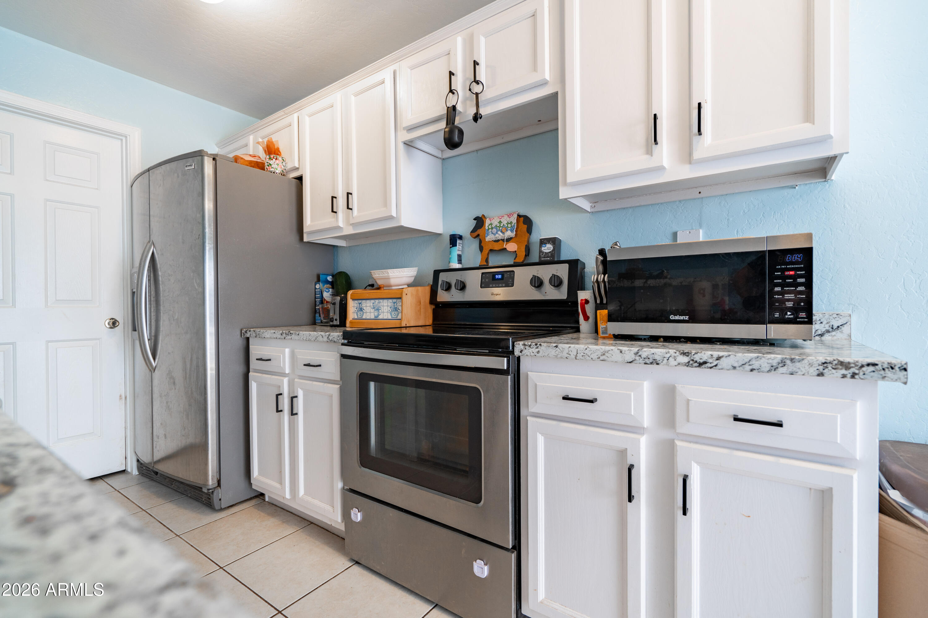 15855 South Moon Valley Road Arizona City, AZ 85123 - Photo 4 of 22 a kitchen with stainless steel appliances granite countertop a refrigerator stove and sink