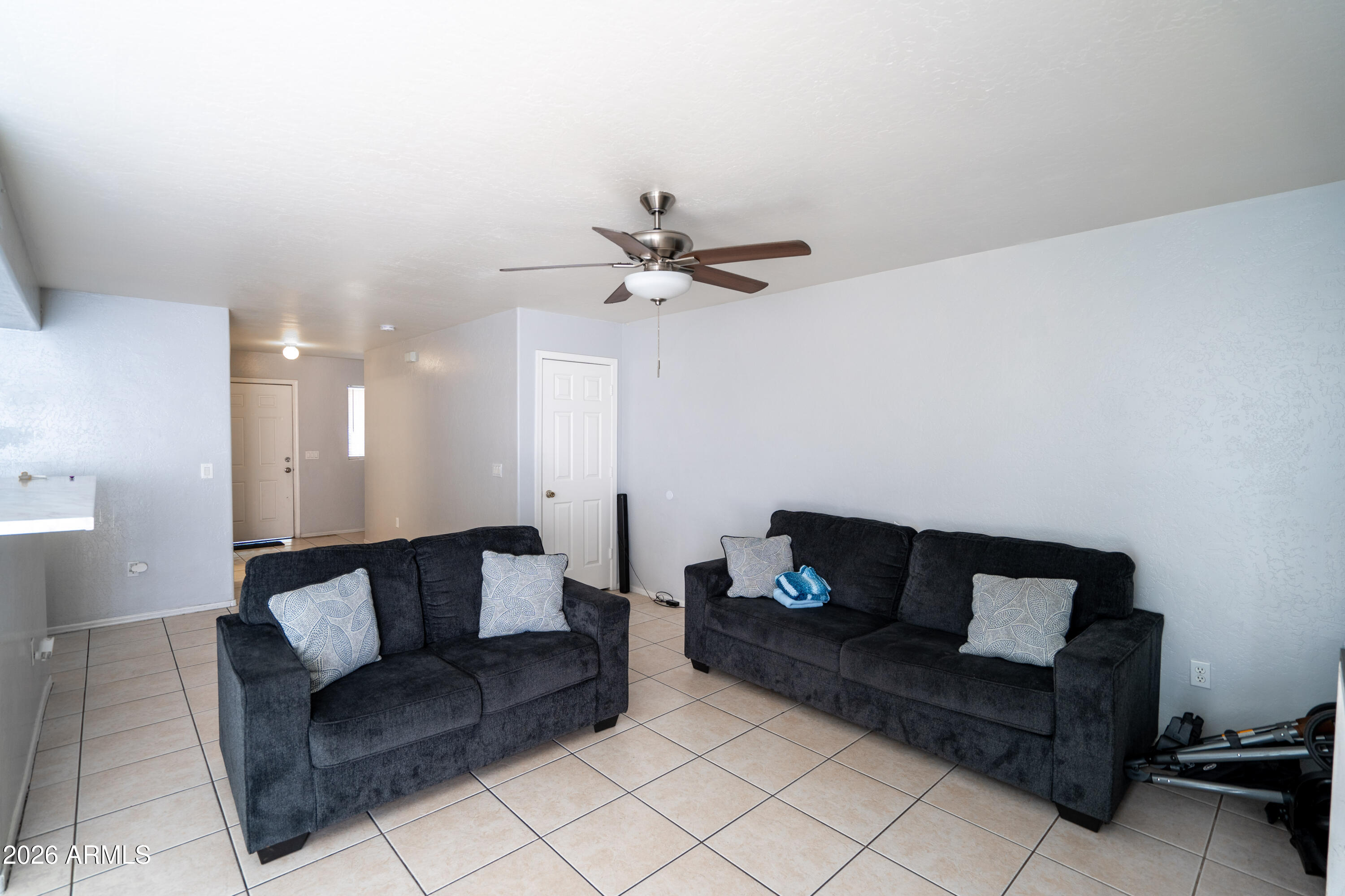 15855 South Moon Valley Road Arizona City, AZ 85123 - Photo 8 of 22 a living room with furniture and a ceiling fan