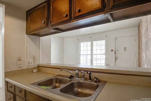 an empty room with wooden floor and a window