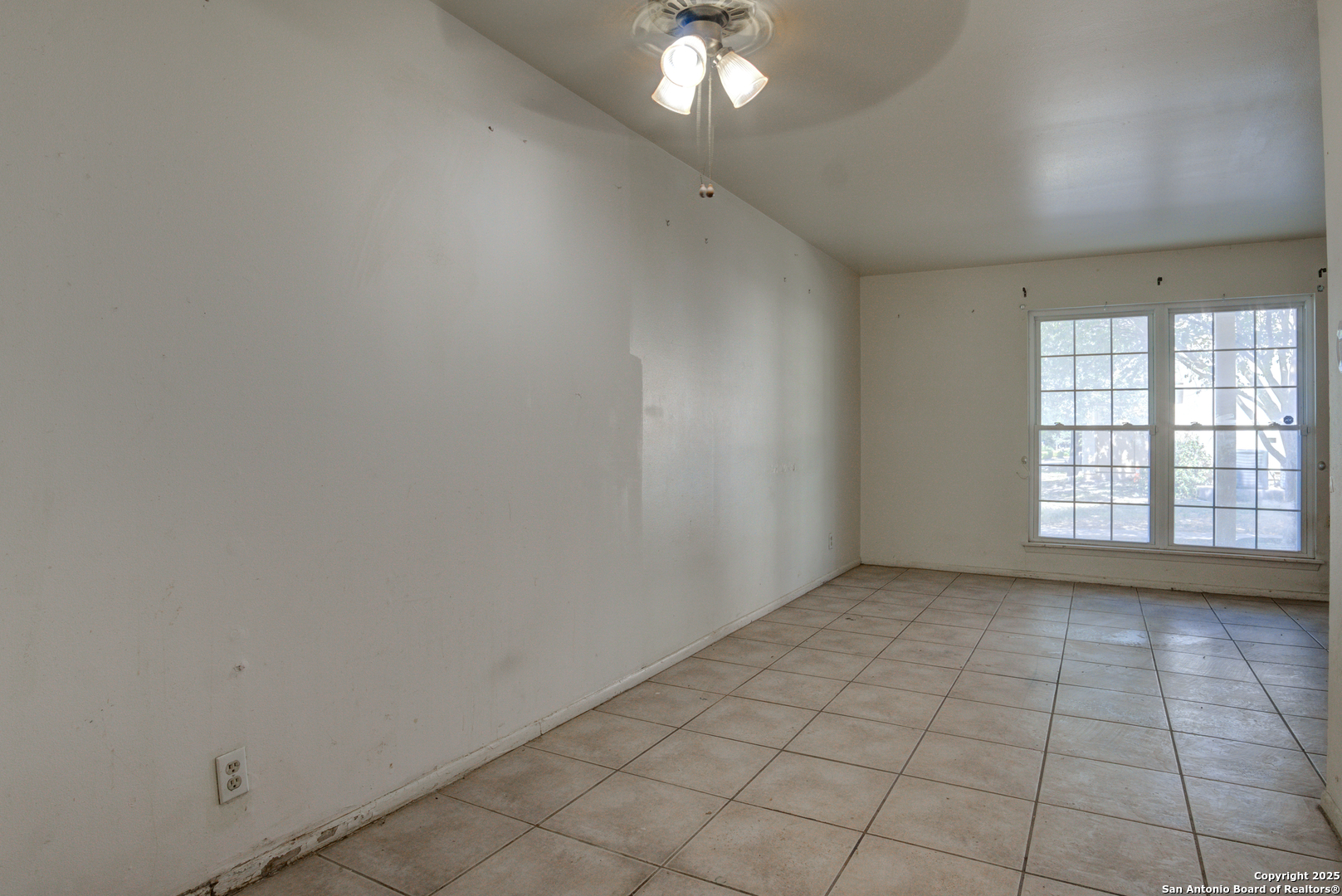 8702 Village Drive, Unit BLDG 8 814 San Antonio, TX 78217 - Photo 17 of 25 wooden floor in an empty room with a window