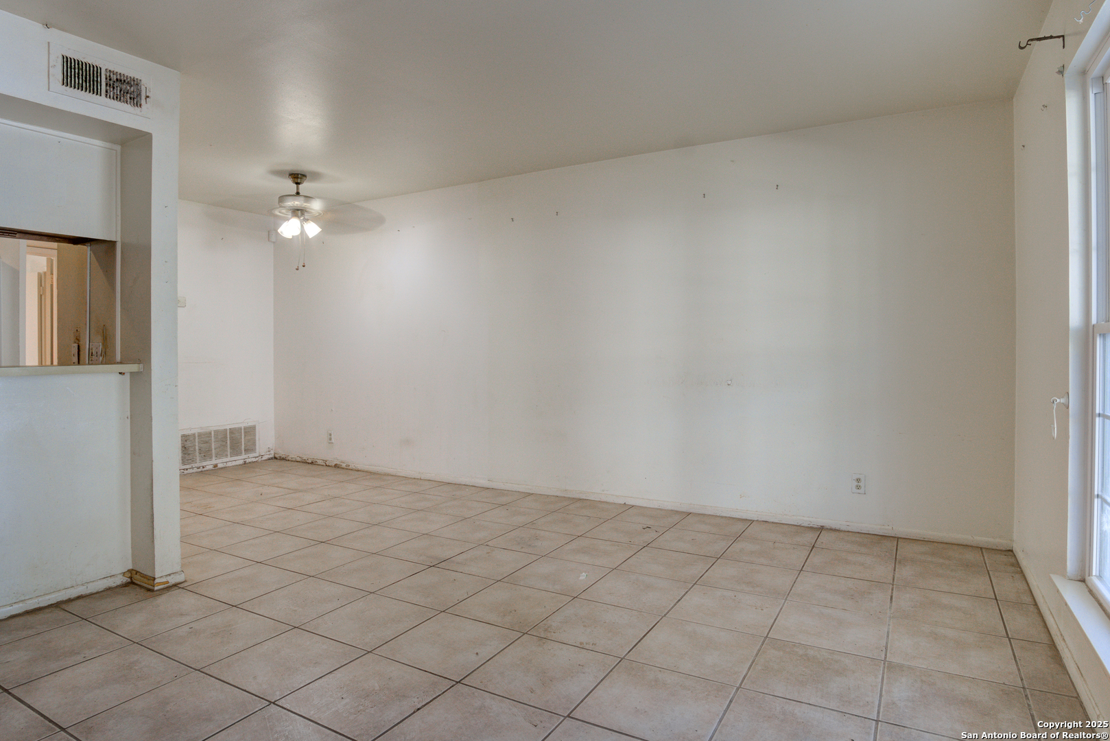 8702 Village Drive, Unit BLDG 8 814 San Antonio, TX 78217 - Photo 6 of 25 an empty room with a chandelier fan