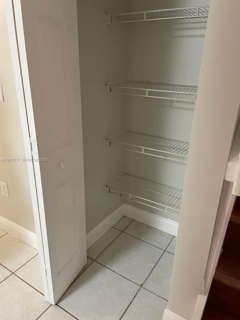 16530 Southwest 96th Terrace Miami, FL 33196 - Photo 14 of 22 a view of walk in closet with empty racks
