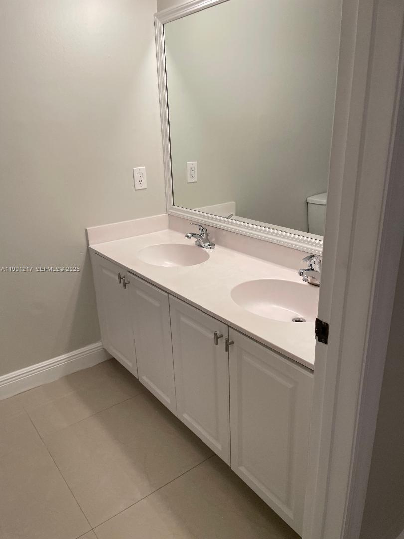16530 Southwest 96th Terrace Miami, FL 33196 - Photo 15 of 22 a bathroom with a sink and a mirror