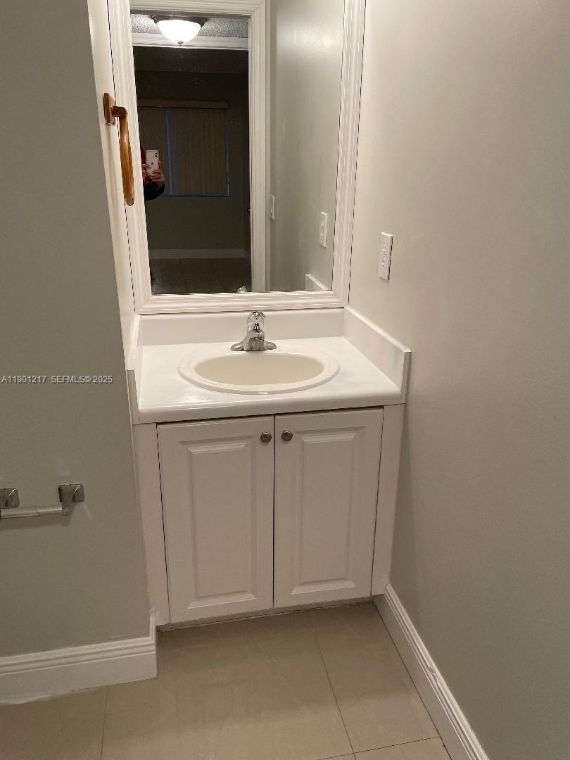 16530 Southwest 96th Terrace Miami, FL 33196 - Photo 18 of 22 a bathroom with a sink and a mirror