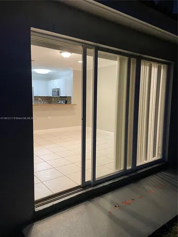an empty room with wooden floor door and closet