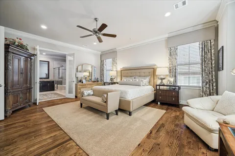 a bedroom with a bed mirror and window