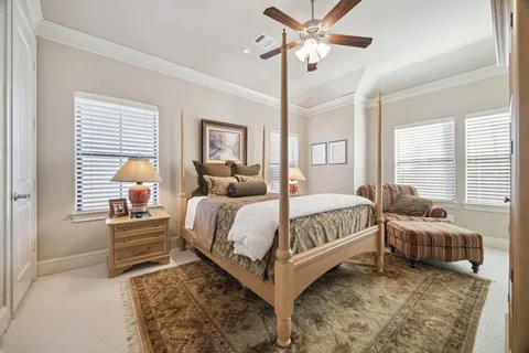 a bathroom with a granite countertop bathtub shower sink vanity mirror and toilet