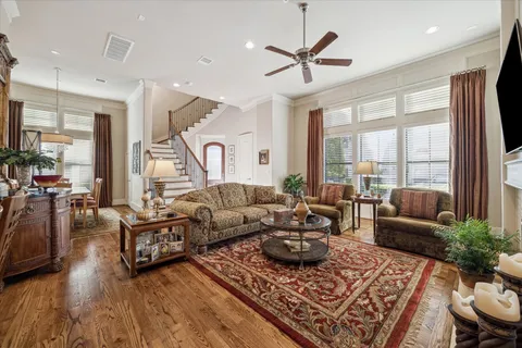 a living room with furniture fireplace and a large window